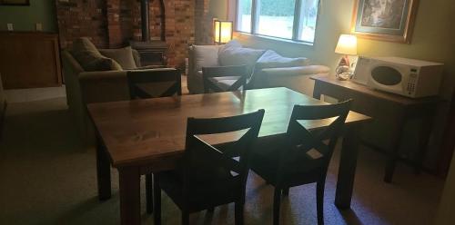a living room with a wooden table and chairs at Riverbend Guest House in Chilliwack