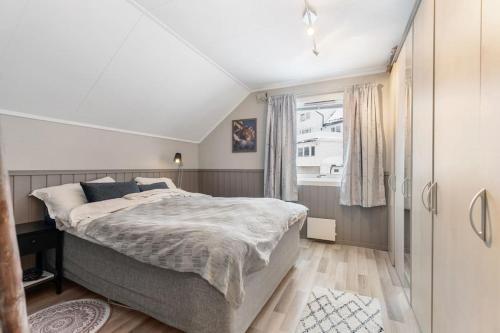 a bedroom with a large bed and a window at Cozy 130sqm house right above the city center. in Tromsø