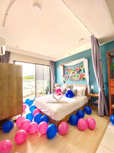 a bedroom with a bunch of balloons around a bed at TIMURBAY KUANTAN SEAVIEW PLUS By Timurbay Arza in Kuantan