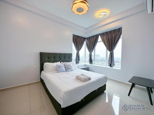 a bedroom with a bed and a window at Melaka Novo 8 Residence - Jonker Street by Stayrene in Melaka