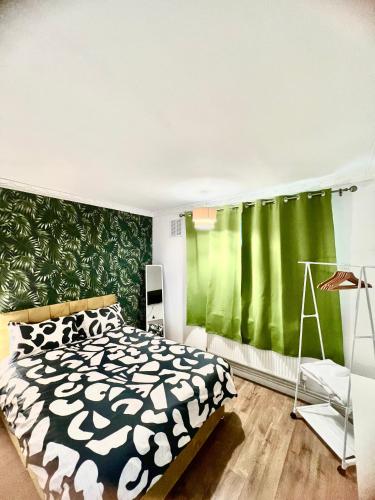 a bedroom with a bed and a green wall at Private double room in the center of london in London
