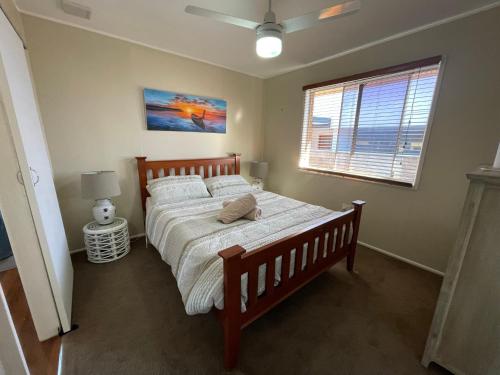 a bedroom with a large bed and a window at Fisher River Front in Griffin