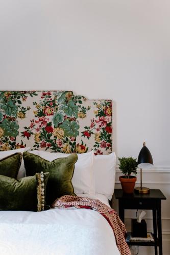 a bedroom with a bed with a floral headboard at Moss Manor in Moss Vale