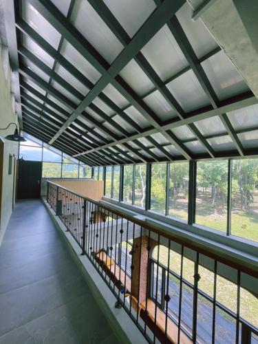 a room with a balcony with a large window at Taroko 767 Farm B&B 太魯閣767農莊民宿 in Xiulin