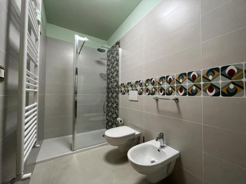 a bathroom with a toilet and a shower and a sink at Il Pepe Affittacamere in Bisceglie