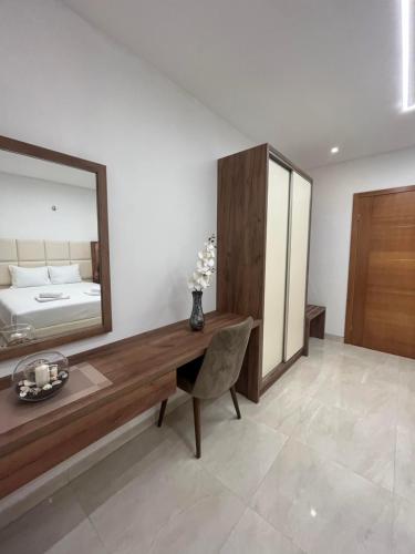 a bedroom with a desk and a mirror and a bed at Arbneshi Apartments in Ulcinj