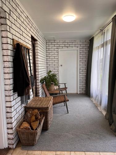a hallway with a bench and a brick wall at King Edi Cottage in Edi