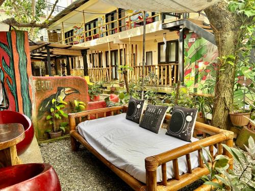 una cama en medio de un patio con plantas en Lazy Dog Bed & Breakfast en Boracay