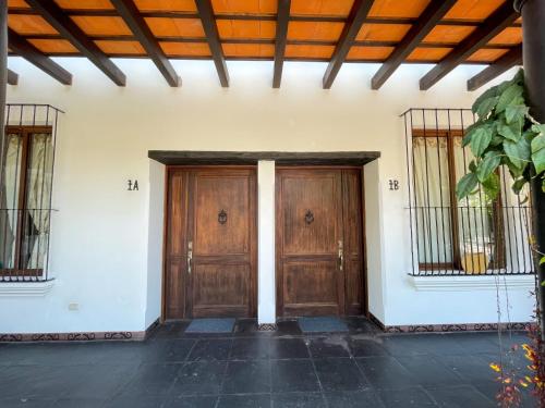 a pair of wooden doors in a building at Boutique Villa in Antigua in Antigua Guatemala
