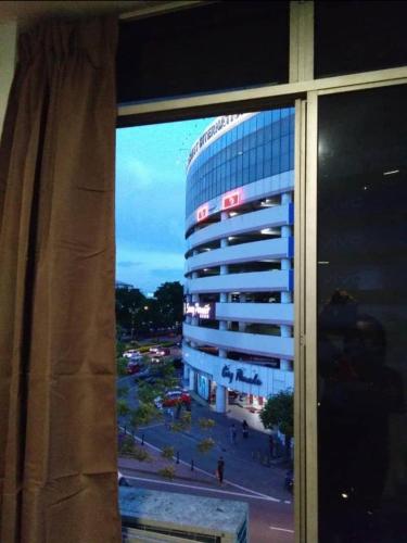 a view of a building from a window at SC Lodging House Sinsuran Complex in Kota Kinabalu