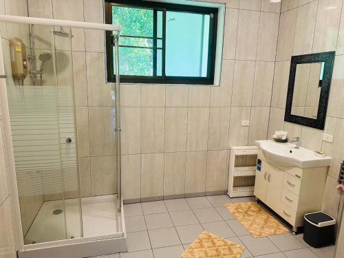 a bathroom with a shower and a sink at House of Garden Resort in Chiang Rai