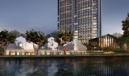 a rendering of a building next to a tall skyscraper at Fraser Residence River Promenade, Singapore in Singapore