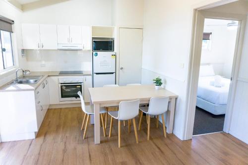 a kitchen and dining room with a table and chairs at Halifax Holiday Park in Nelson Bay