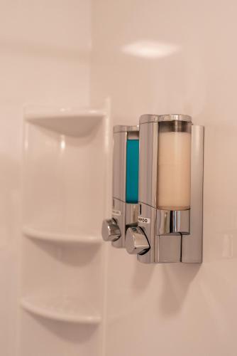 a wall mounted soap dispenser on a wall at Motel Torrey in Torrey
