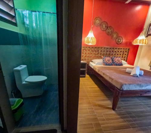 ein Schlafzimmer mit einem Bett und einem WC in einem Zimmer in der Unterkunft Coracasa bed and breakfast in General Luna