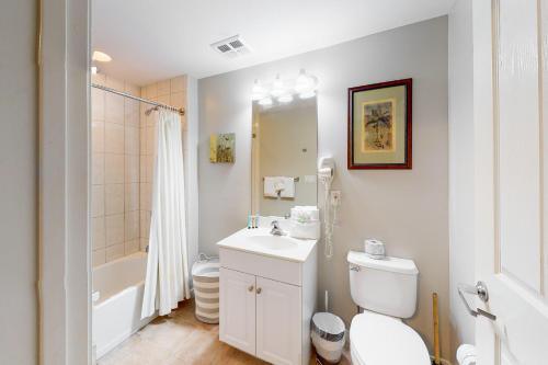 a white bathroom with a toilet and a sink at Destin West Resort - Gulfside 207 in Fort Walton Beach
