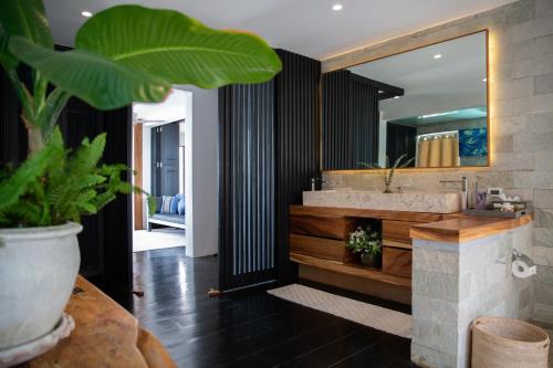 a bathroom with a sink and a mirror at Villa U - Beachfront Haven in Lipa Noi