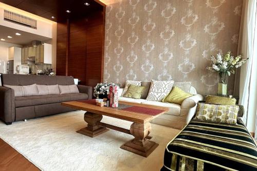 a living room with a couch and a coffee table at Straits Quay Highest & Spacious Seaview Suite - 2 in Tanjong Tokong