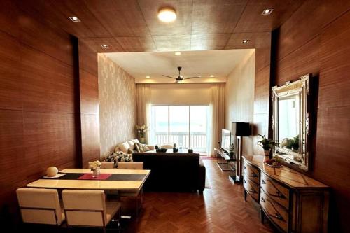a living room with a table and a couch at Straits Quay Highest & Spacious Seaview Suite - 2 in Tanjong Tokong