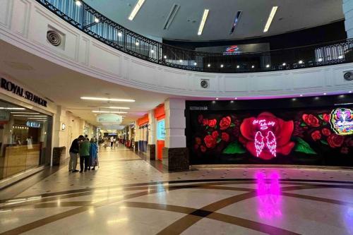 a shopping mall hallway with a large flower mural at Straits Quay Highest & Spacious Seaview Suite - 2 in Tanjong Tokong