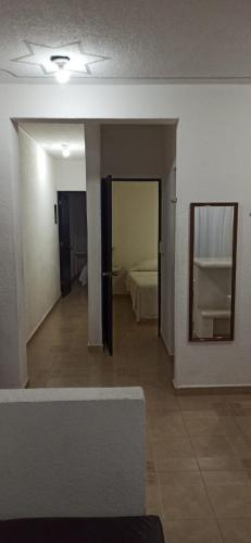 a room with a room with a bed and a mirror at QUINTA DIAMANTE villas&hotel in Barra Vieja