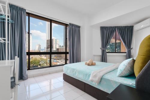 a bedroom with a bed and a large window at Bukit Bintang Times Sq With 3 Bedroom 74 in Kuala Lumpur