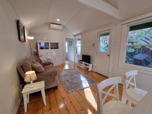 a living room with a couch and a table and chairs at Doongarra in Queenscliff