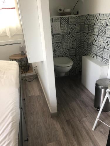 a small bathroom with a toilet and a sink at STUDIO 11m2 in Magny-Cours