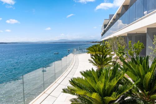 a view of the ocean from the balcony of a building at Luxury Hotel Amabilis in Selce