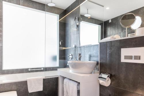 a bathroom with a sink and a mirror at Luxury Hotel Amabilis in Selce
