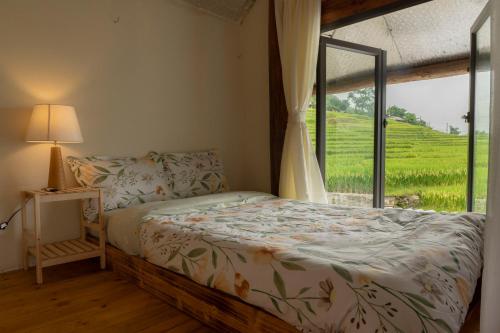 a bedroom with a bed and a window with a view at Moc Home Sapa in Sapa