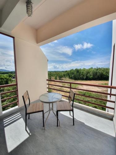 a table and two chairs on a balcony with a view at Sea Sand Sun Resort in Rayong