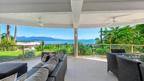 a living room with a couch and a view of the ocean at Island Point Villa 1 Port Douglas in Port Douglas