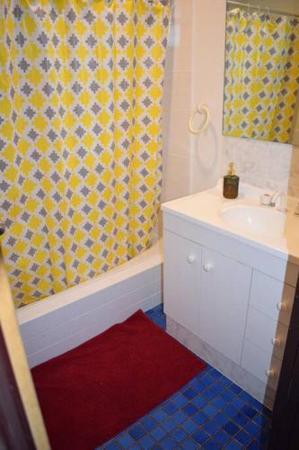 a bathroom with a sink and a shower curtain at Piccadilly Accommodation in Kalgoorlie