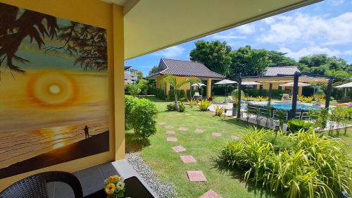 a view of a pool from a house with a painting at Residence M Thailand, Resort, Mae Ramphueng Beach, Ban Phe, Rayong, Residence M Thailand in Ban Chamrung