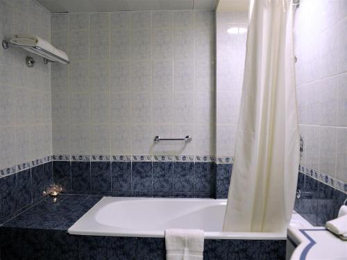 a bath tub with a shower curtain in a bathroom at Signature Inn Hotel in Dubai