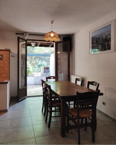 une salle à manger avec une table et des chaises en bois dans l'établissement Villa des arbres, à Trets