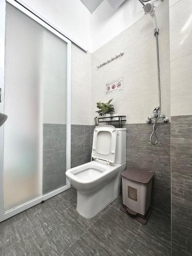 a bathroom with a toilet and a shower at Khoảng Lặng ATP in Da Lat