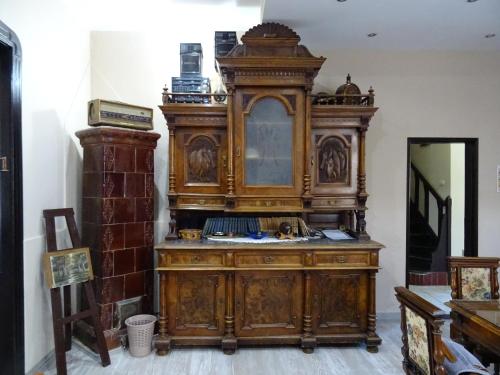 a large wooden cabinet in the corner of a room at Mia Casa in Novi Sad