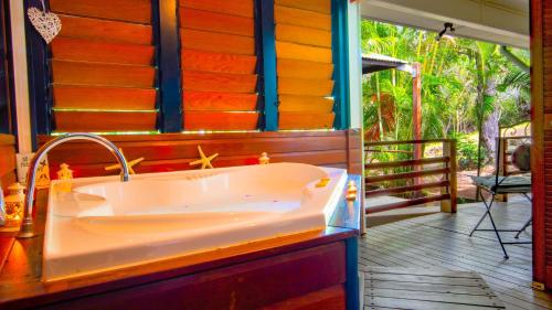 a bath tub sitting on the porch of a house at Sunbird Gardens Villa 3 in Agnes Water