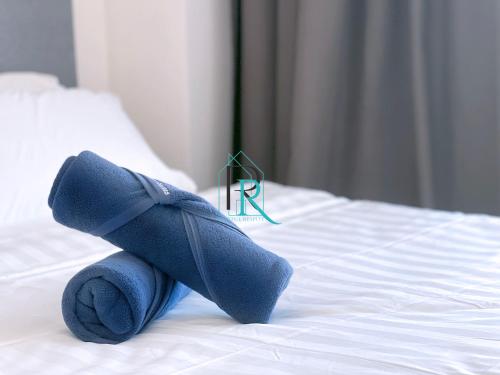 a stuffed animal on top of a bed at Restful Respite Tanjung Aru Inifnity Pool 2BR in Kota Kinabalu