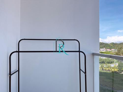 a sign with the letter r on it in front of a window at Restful Respite Tanjung Aru Inifnity Pool 2BR in Kota Kinabalu