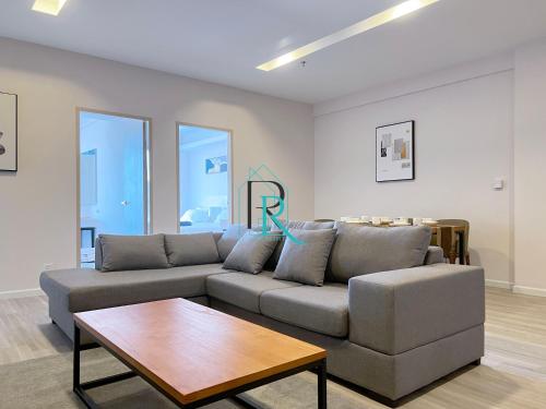 a living room with a couch and a coffee table at Restful Respite Tanjung Aru Inifnity Pool 2BR in Kota Kinabalu