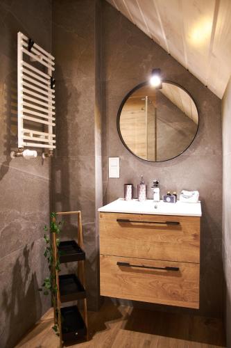 a bathroom with a sink and a mirror at Siedlisko Malechowo in Ustronie Morskie