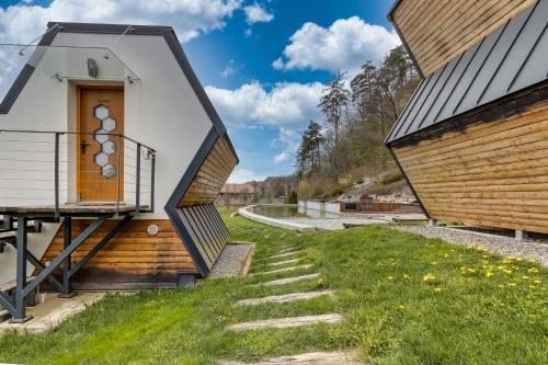a house with a staircase between two buildings at Honeycomb Chalets And Apartments Mozirje in Mozirje