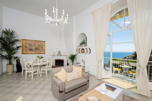 a living room with a view of the ocean at House on the rock in Positano