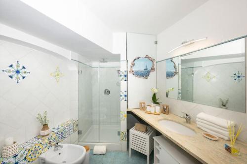 a bathroom with a sink and a shower at House on the rock in Positano
