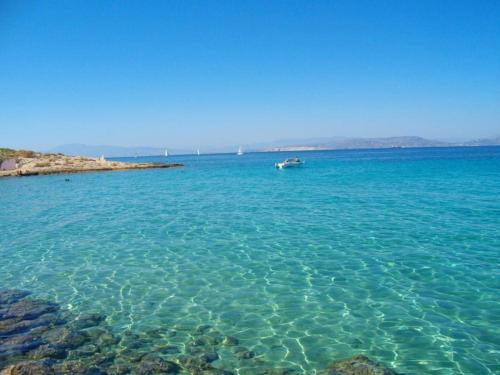 a large body of water with a boat in it at Explore Aegina Island in Souvala
