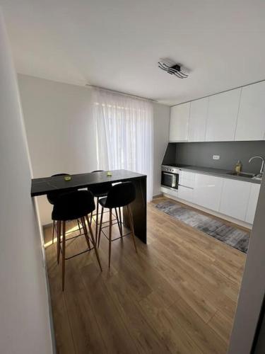 a kitchen with a table and chairs in a room at Studio Kala in Mostar