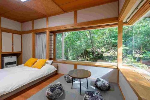 a bedroom with a bed and a large window at S-villa Karuizawa - Princeland - in Tsumagoi
